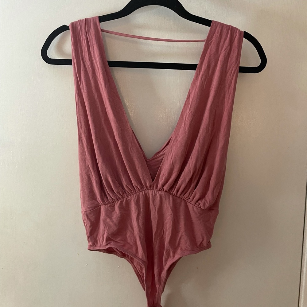 brand is Mikey&Joey, blush/light pink body suit with deep neckline, size medium